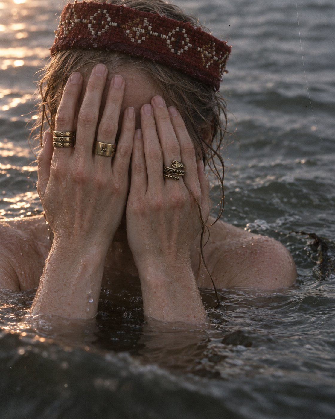 Brass rings worn on a hand at sunset