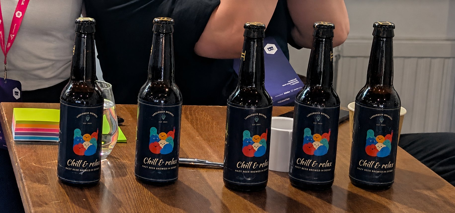 Five Chill and relax bottles lined up on the booth table at Meet Magento UK